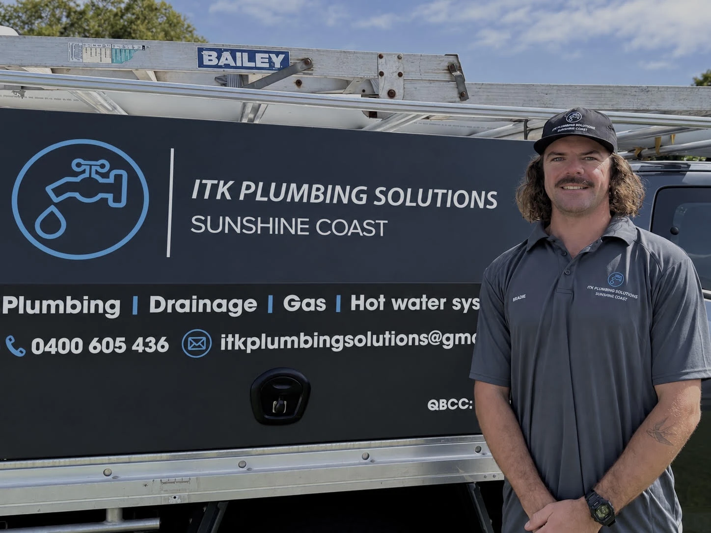 Bradie Steiner standing beside the ITK Plumbing Solutions ute