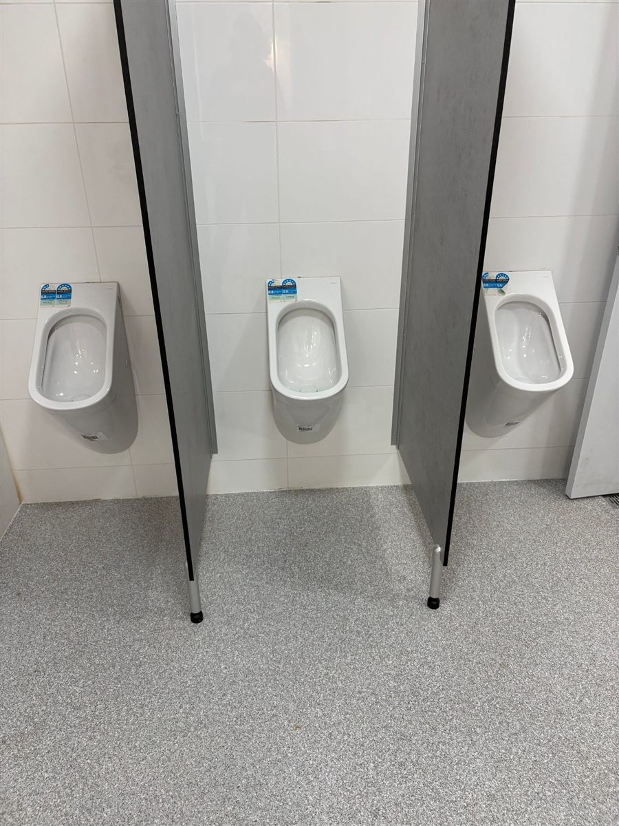 Commercial bathroom with three urinals